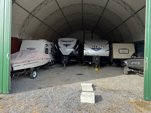 Travel trailers and boats parked inside the dome building